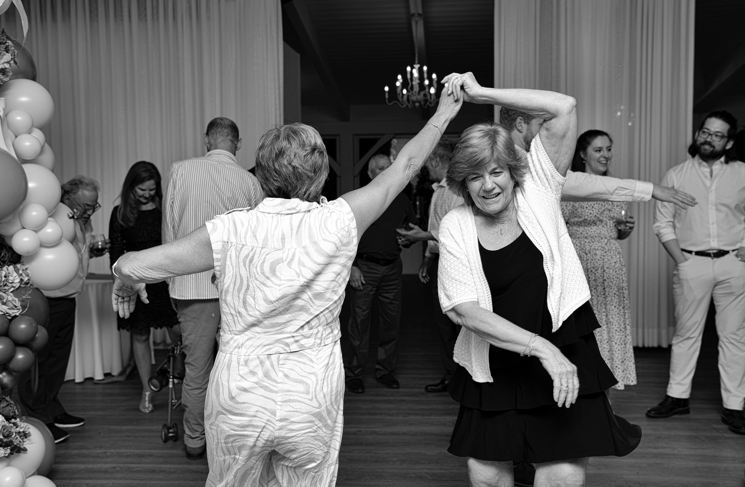 Sisters dancing together at Belle Mer