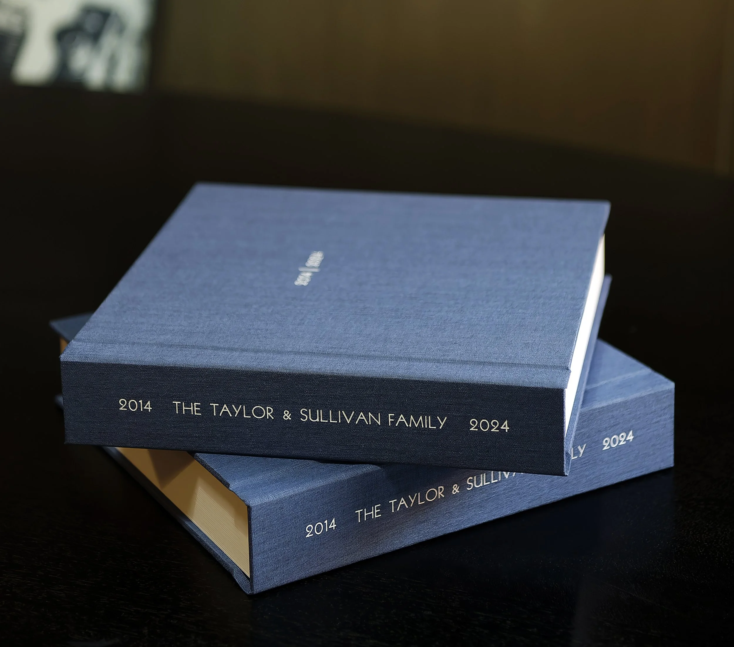 Fine Art family photography album with blue linen book cloth and white foil text on cover.
