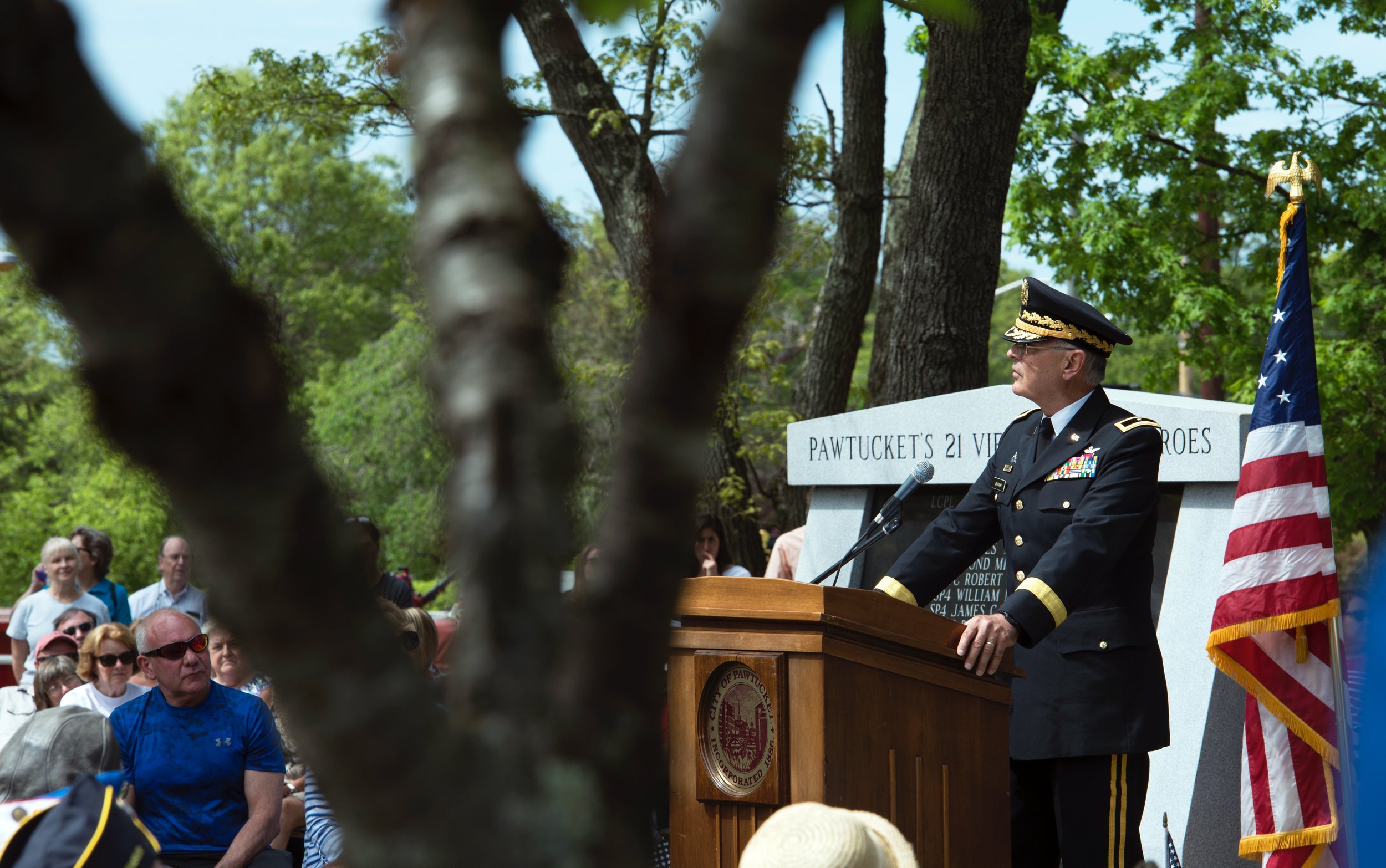Military officer speaking from the podium during the annual remembrance at Slater Park in Pawtucket, Rhode Island.