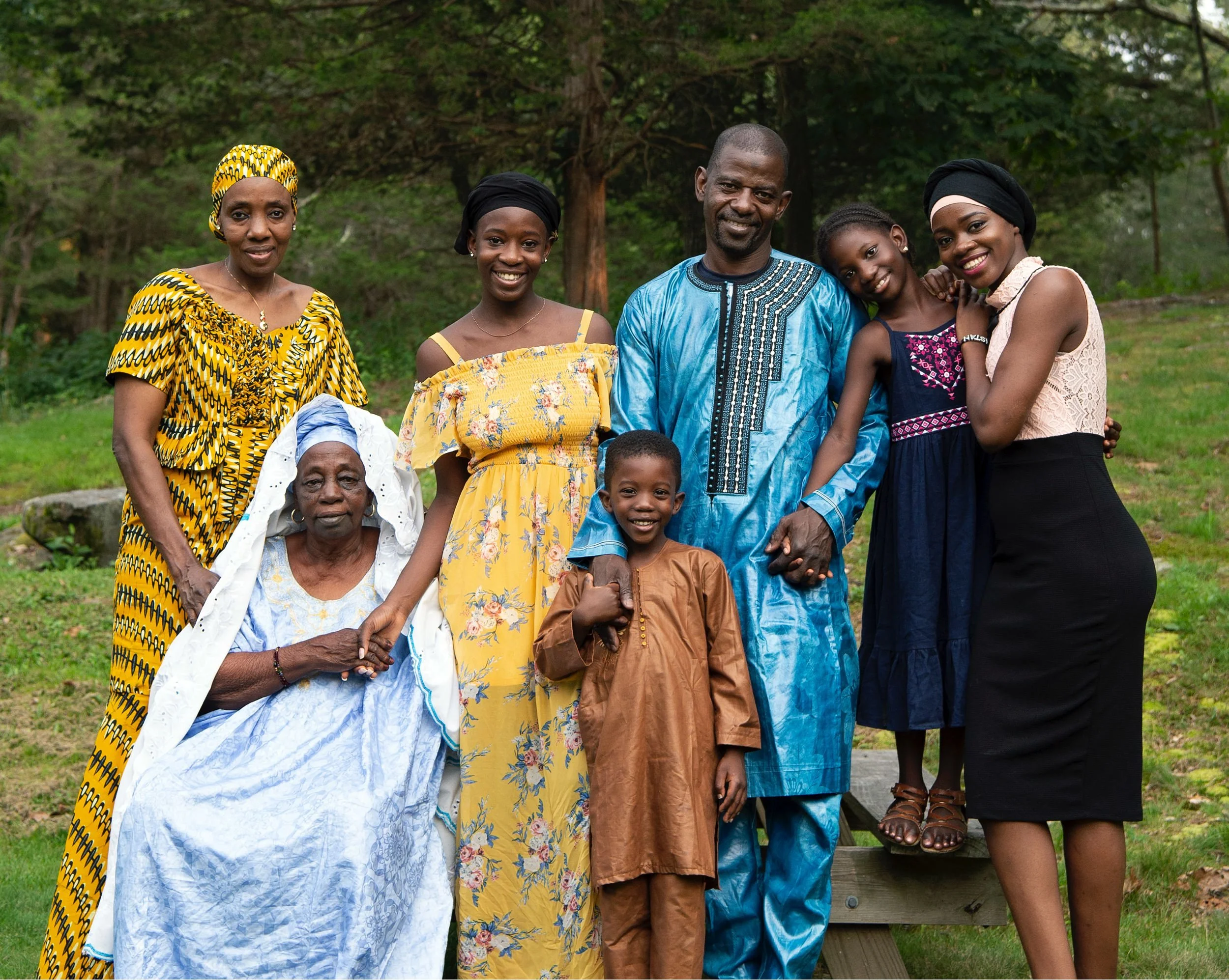 Three generations of the Coulibaly family smiling together at Lincoln Woods Park.
