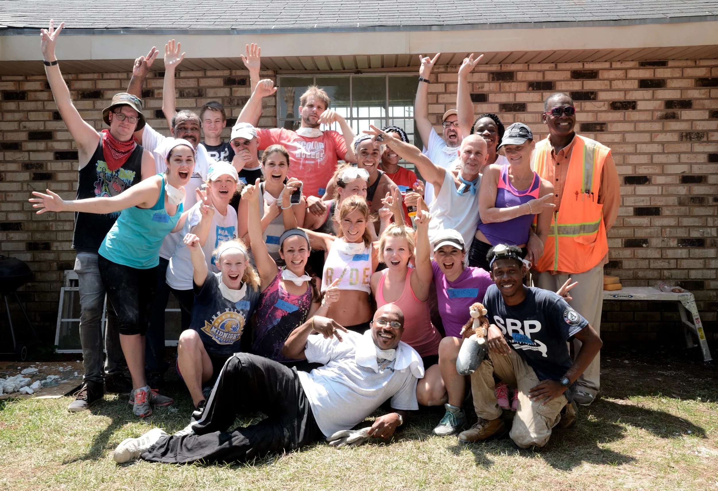 Volunteers gather for a group portrait after completing home rebuilding work with the Saint Bernard Project.