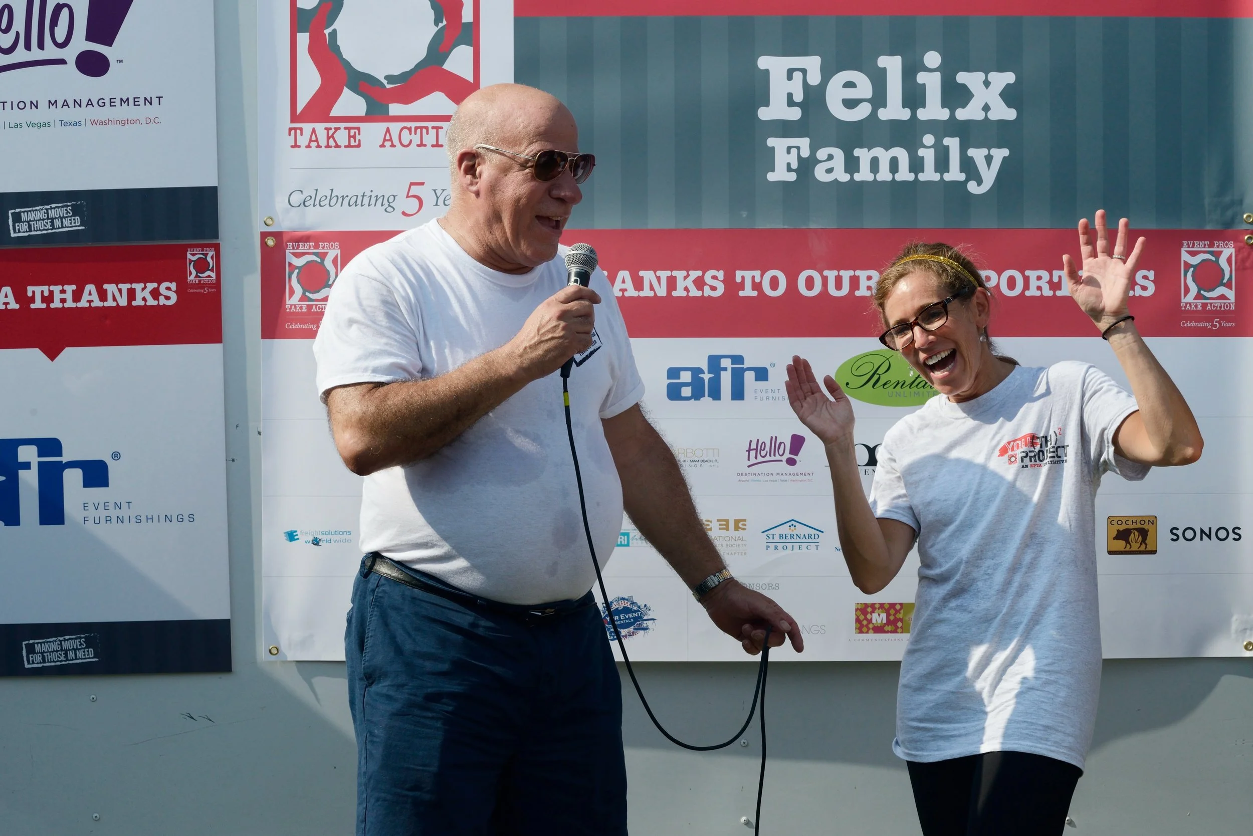 Larry Green and Susie Perelman presenting during house ribbon cutting event for Saint Bernard Project.
