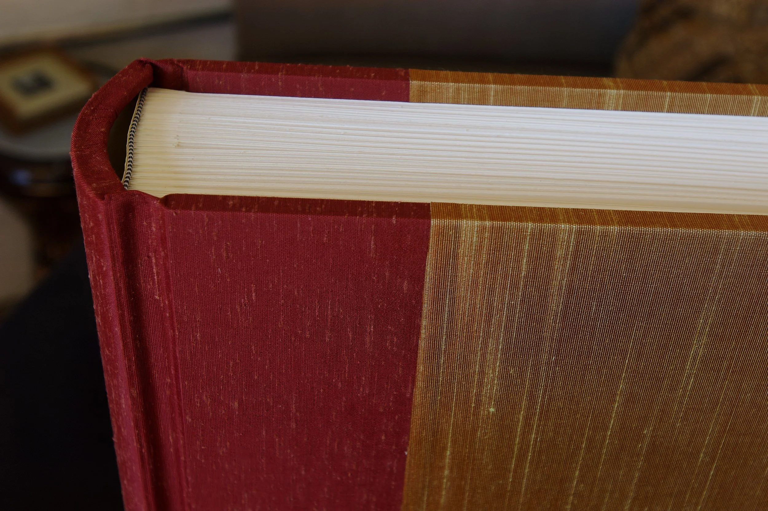 Close up of album with two Japanese silk book cloths on spine and body