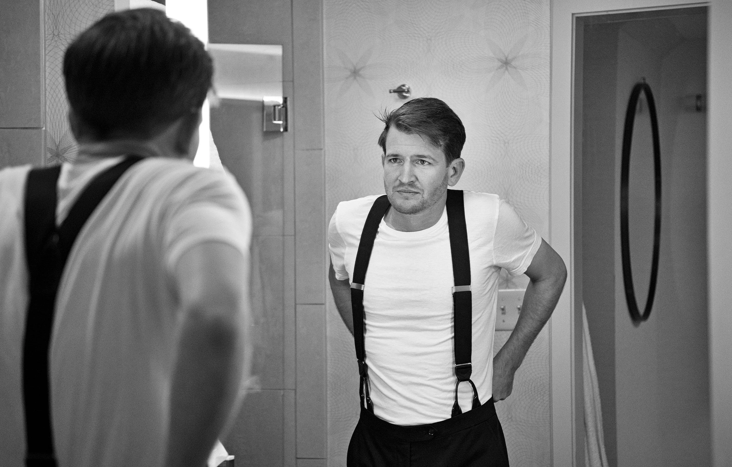 Candid moment of groom during his wedding day preparation at Gurney's Resorts