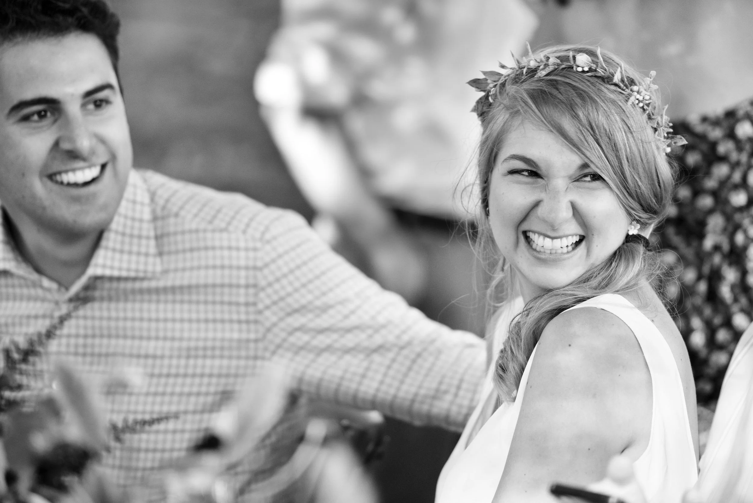 Black and white of Lindsey and Kenneth listening during rehearsal dinner toasts