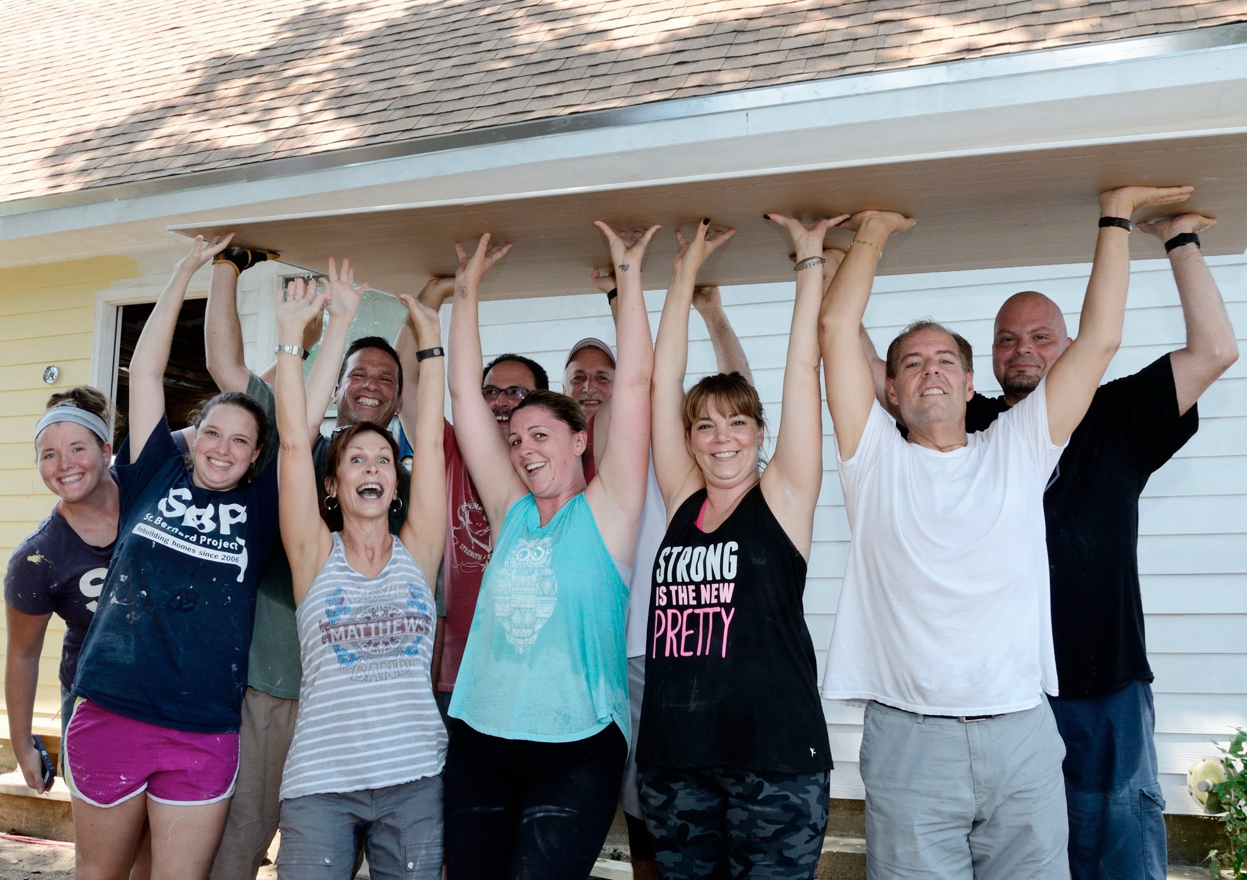 Saint Bernard Project volunteer team celebrating a successful day of rebuilding in New Orleans.