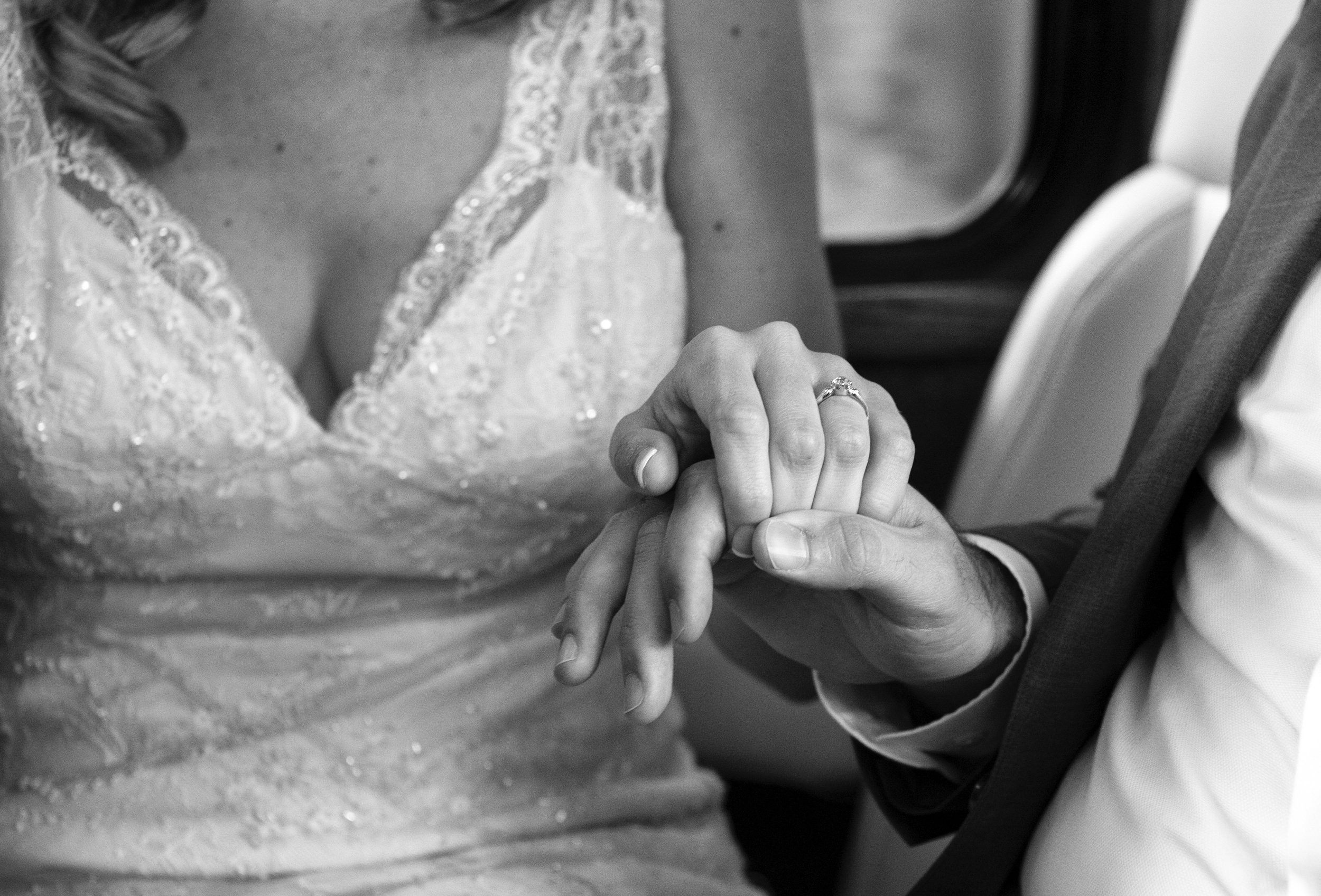 Close-up of the bride and groom holding hands
