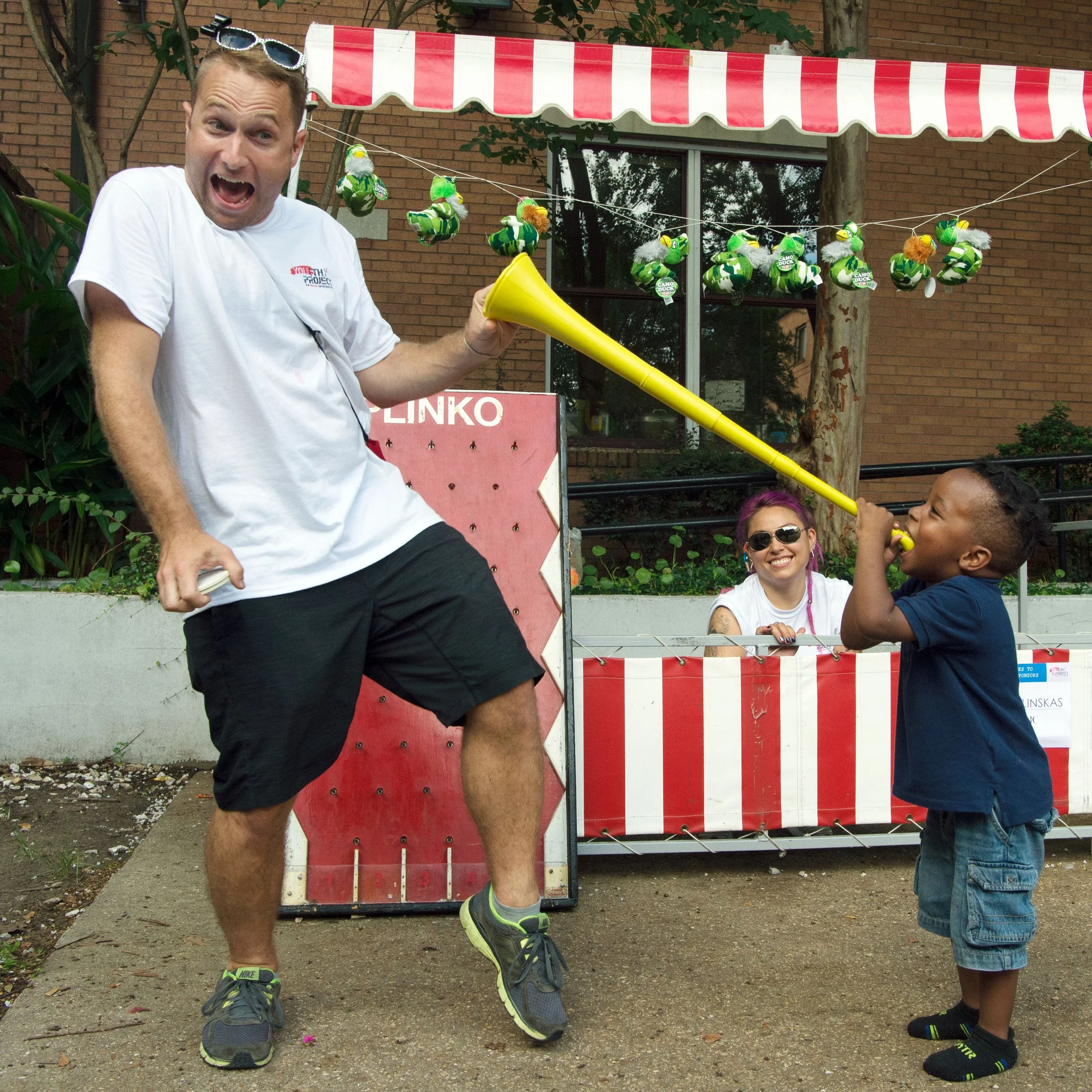 Volunteer Bobby Dutton of GBM6 playing carnival games with children at Covenant House.