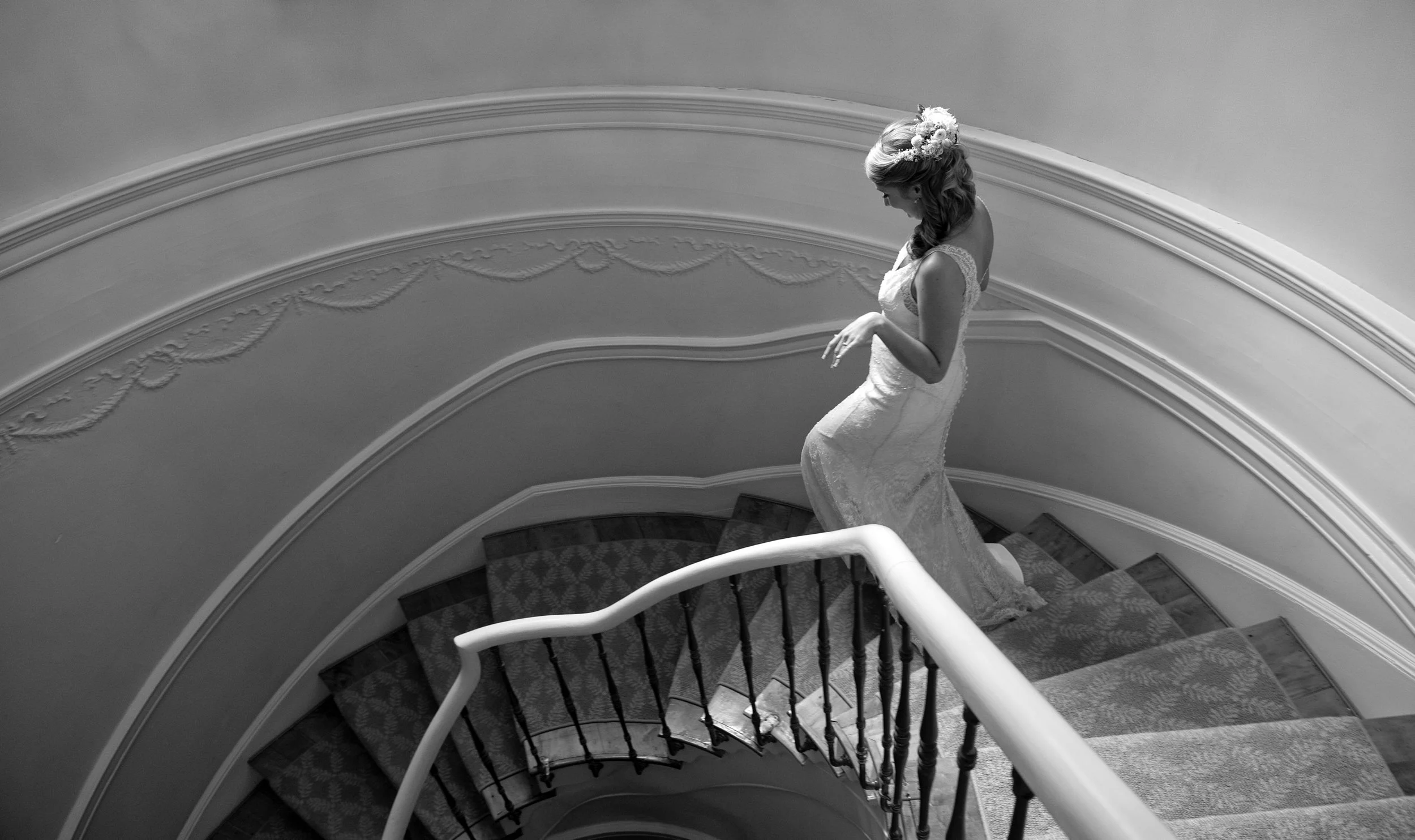 Bride walking down a twirl staircase