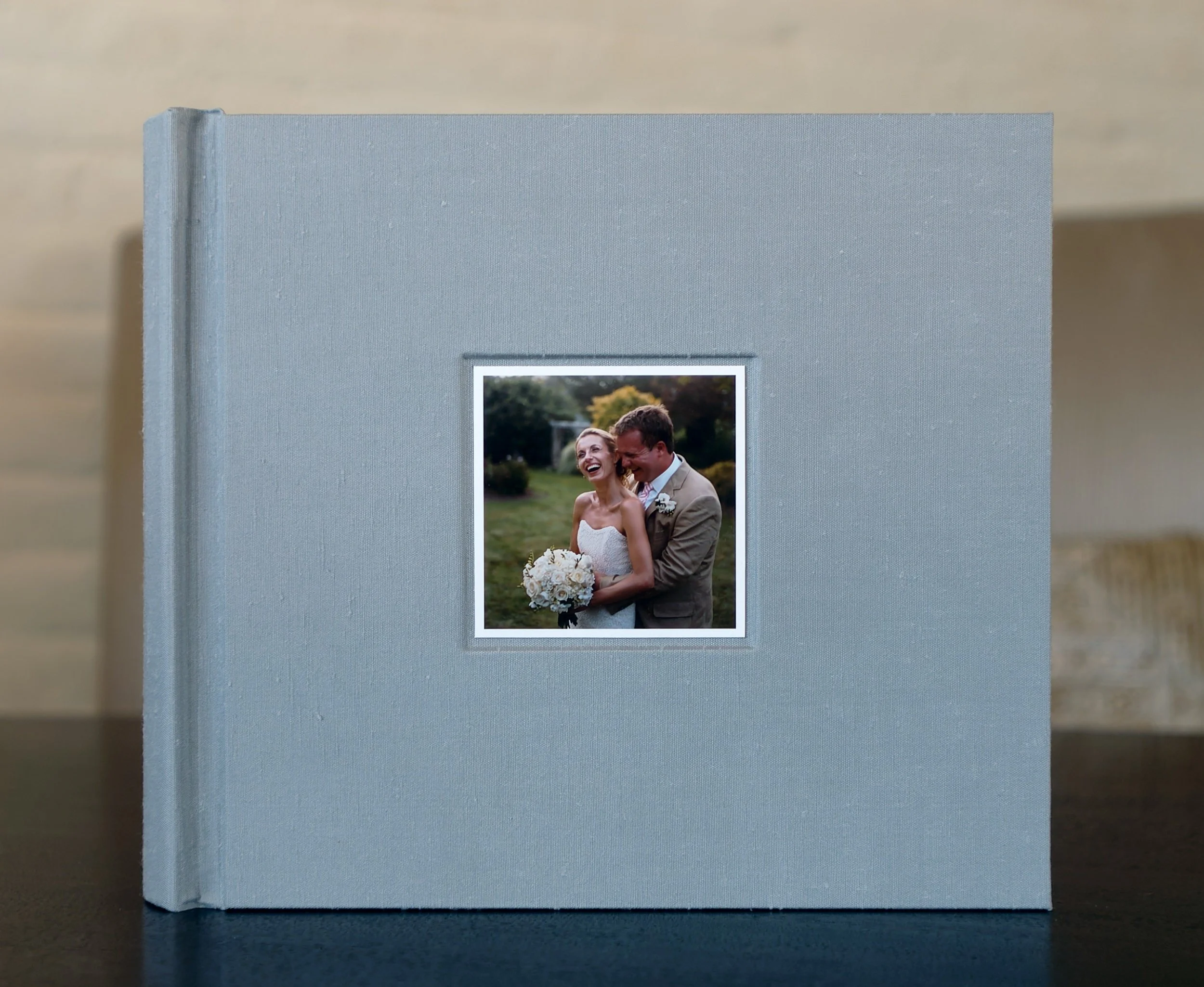Blue-grey shantung silk album with inset photograph, hand-bound by an expert bookbinder.