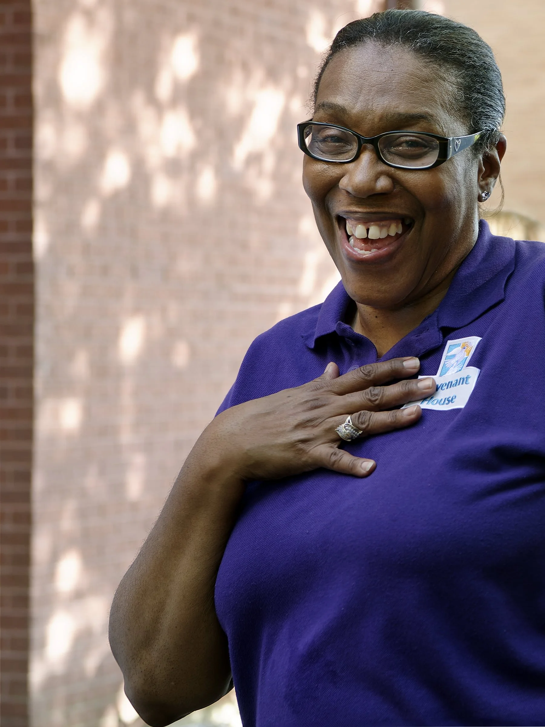 Candid portrait of a Covenant House staff member with big welcoming smile in New Orleans, Louisiana.