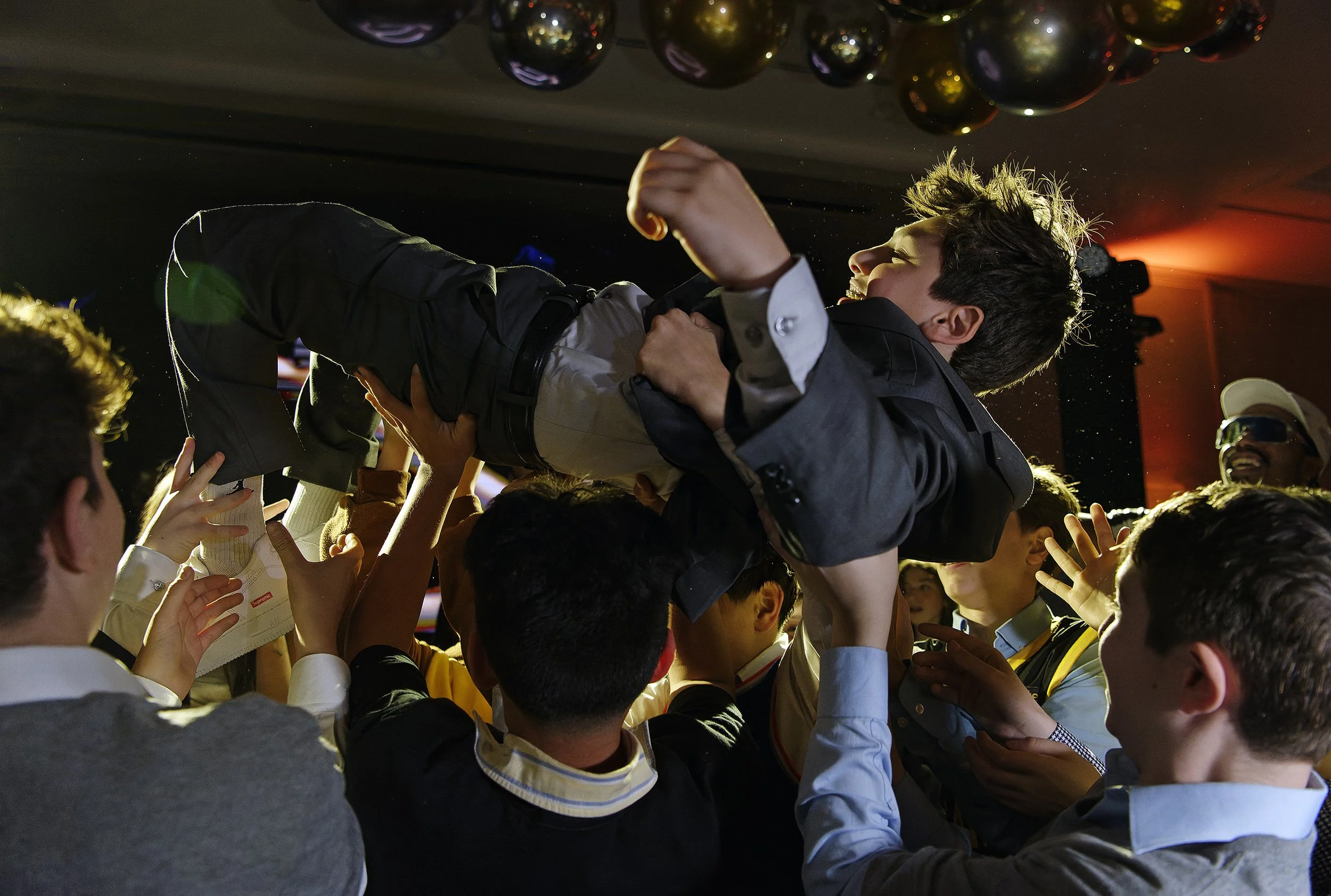 The Bar Mitzvah boy lifted by his friends crowdsurfing during his party entrance.