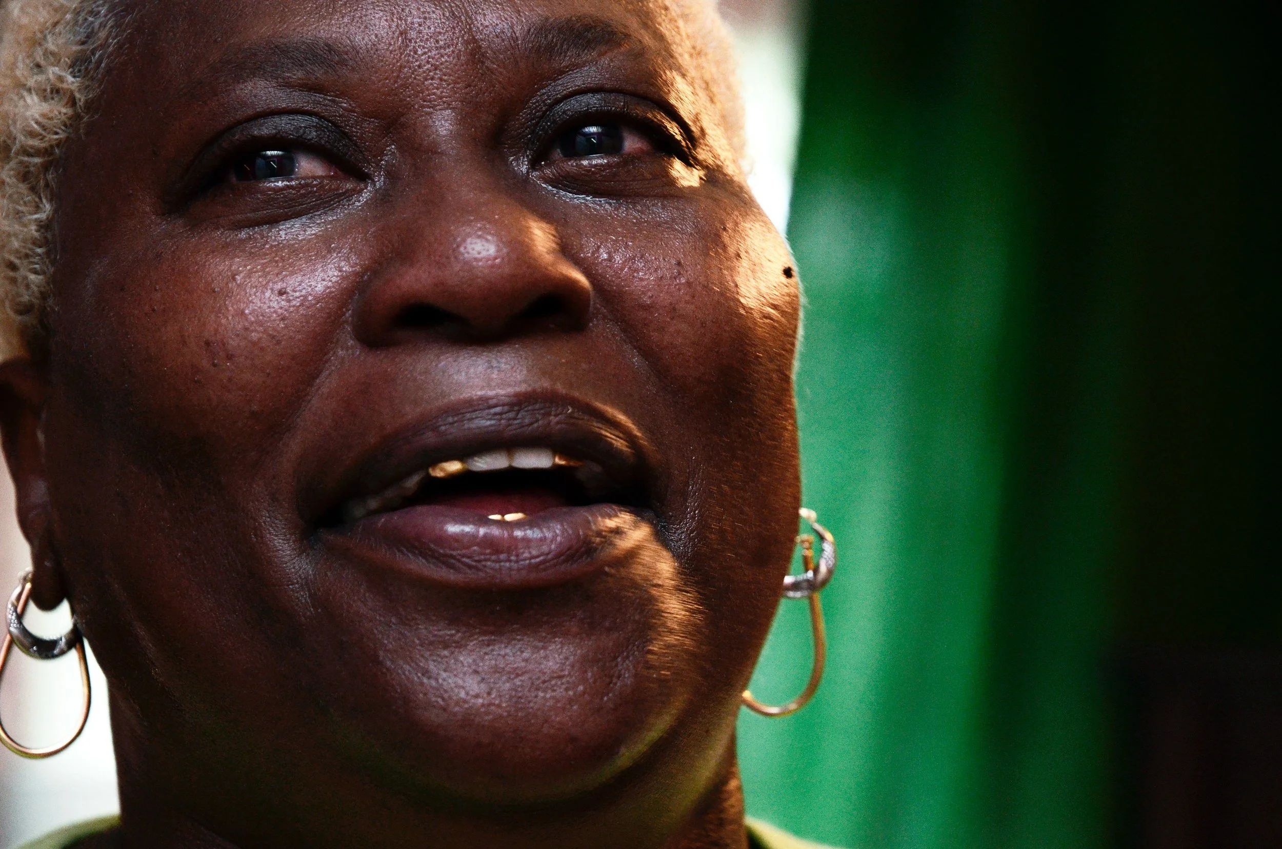 Portrait of a New Orleans homeowner sharing her story during a Saint Bernard Project home dedication.