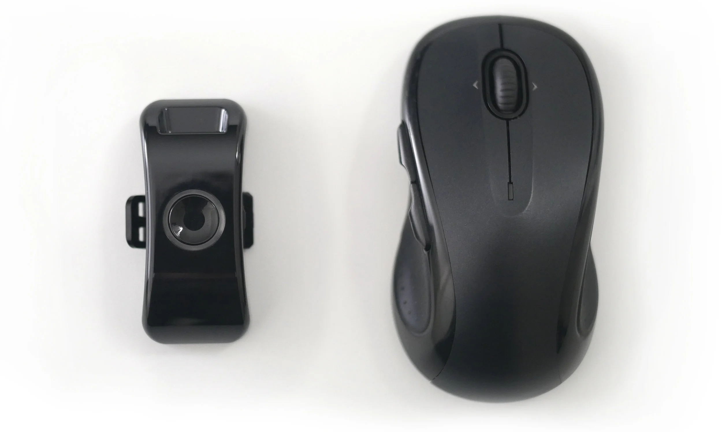 LightMode controller (left) next to a computer mouse (right) to demonstrate relative size.