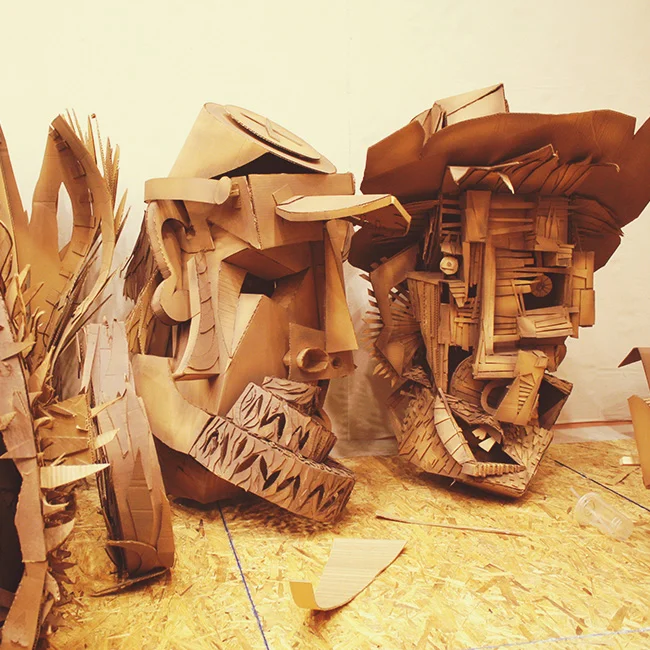 Cardboard puppet heads in progress.