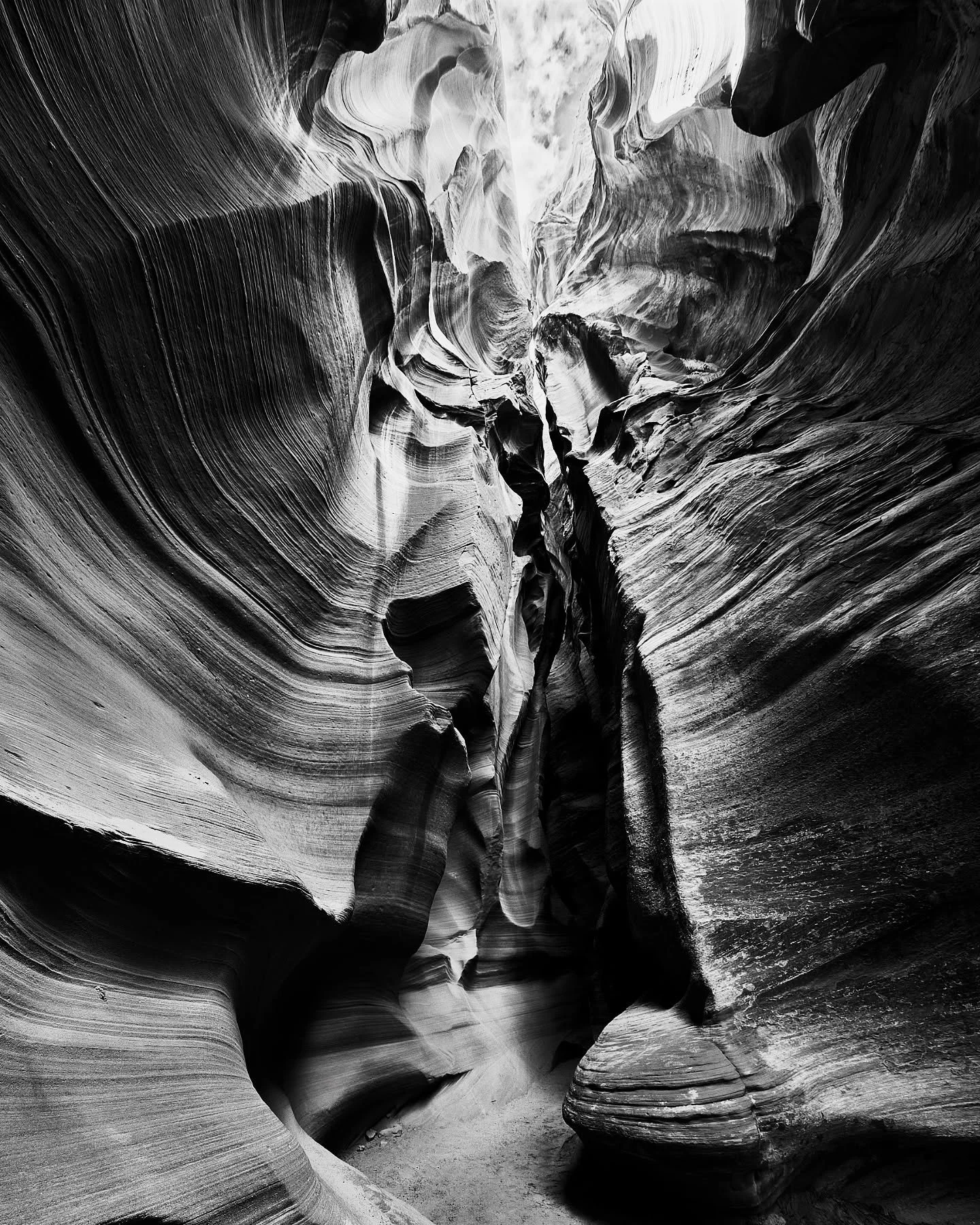 Beneath the sunlit surface of Arizona, stone breathes in slow silence.
Here, shadow and light carve their own language into the sandstone —
a cathedral not of glass, but of time itself.
Antelope Canyon in monochrome feels like a secret whispere