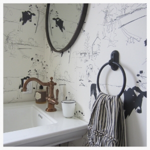 A much-needed powder room was carefully carved from extra space in the laundry room of a Wine Country get-away. Includes a wink to farm land whimsy with cow wallpaper imported from the UK.