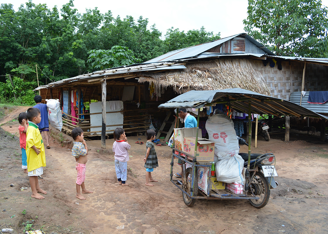 One household buys goods from the town and resells them to the other households.