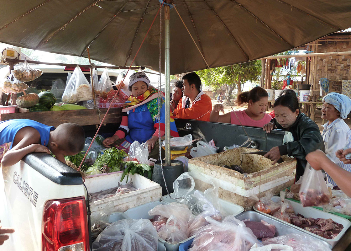 The locals buying groceries from a truck that comes to the community