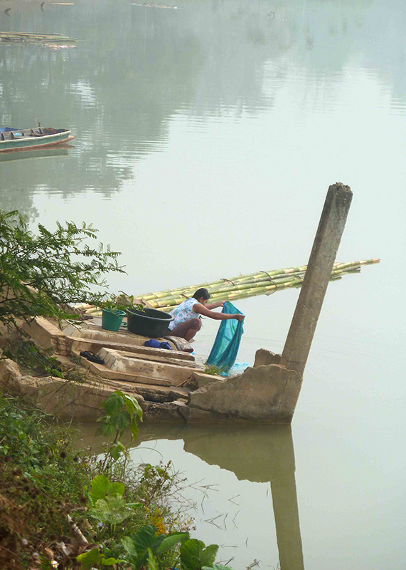 A local doing laundry by the river