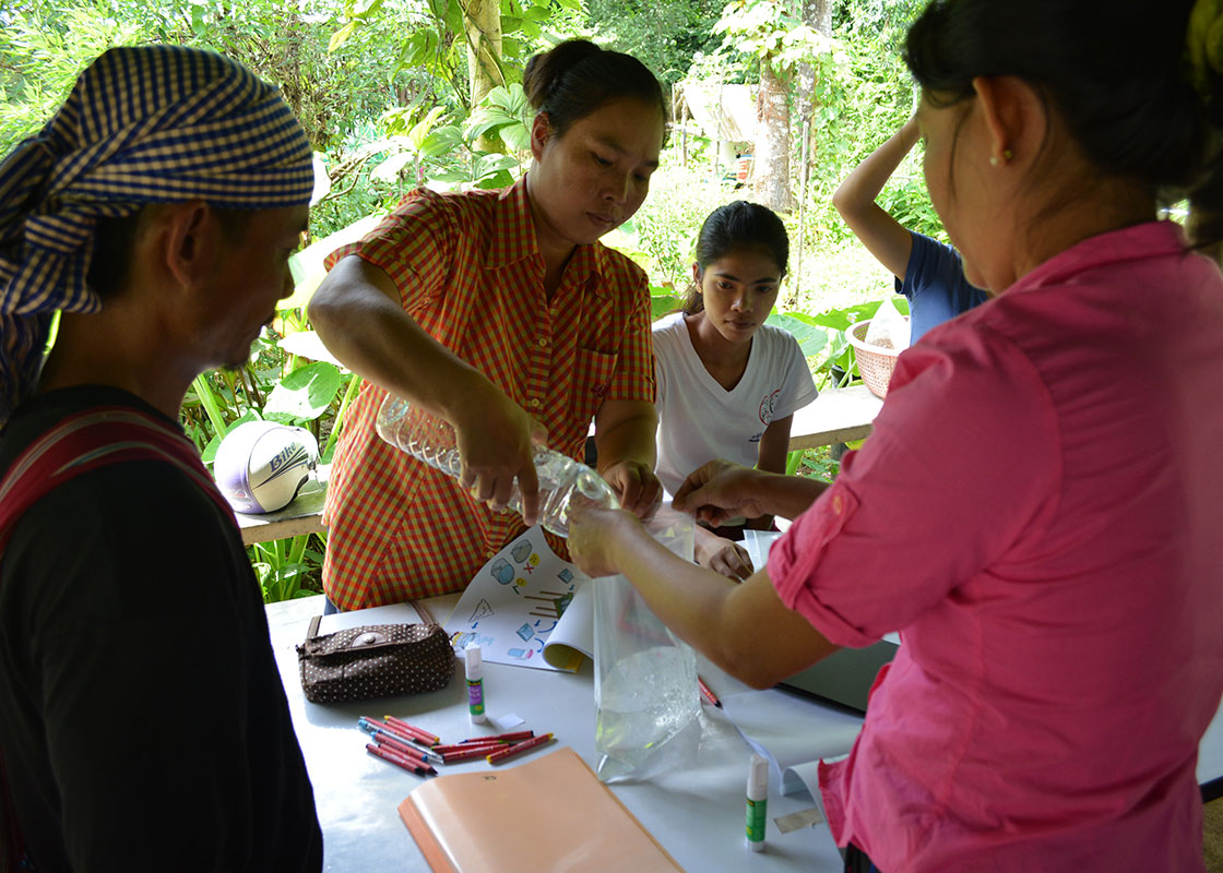 Participants practicing how to use a SODIS bag for disinfecting water.