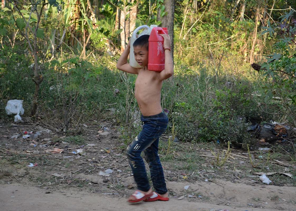 A boy from another family carried water back to his house.