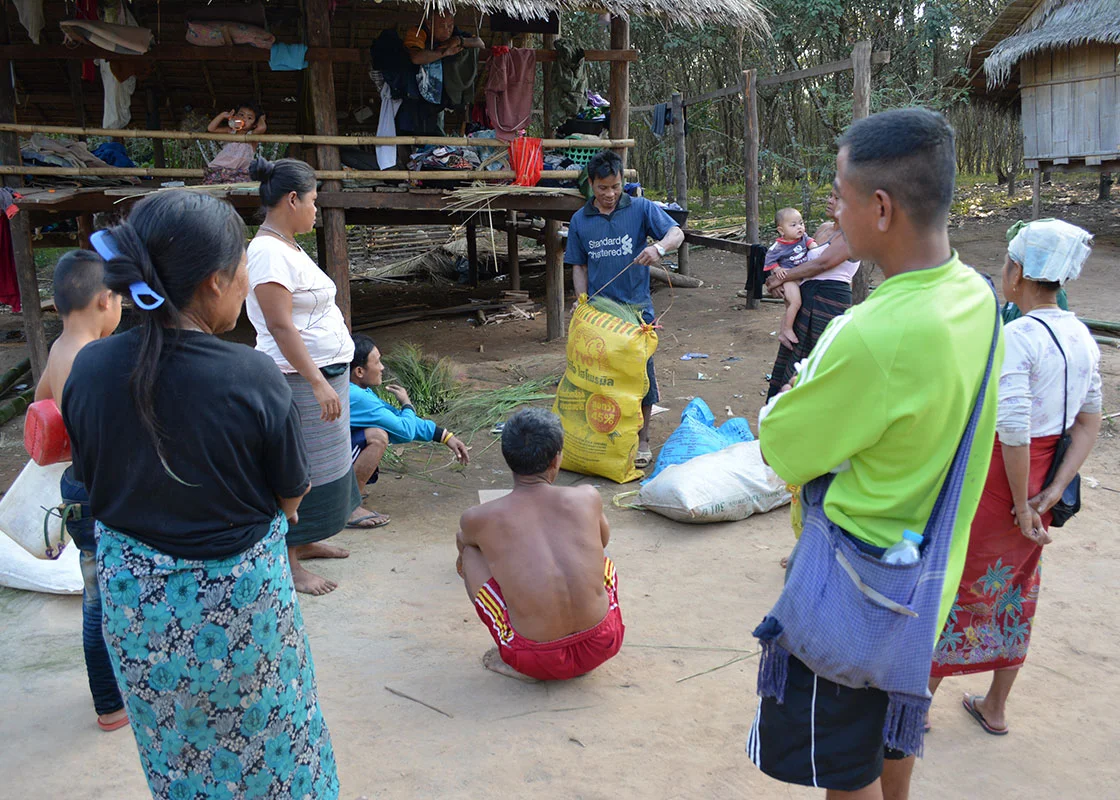 A middle man came to buy broom brushes that the local people had made.