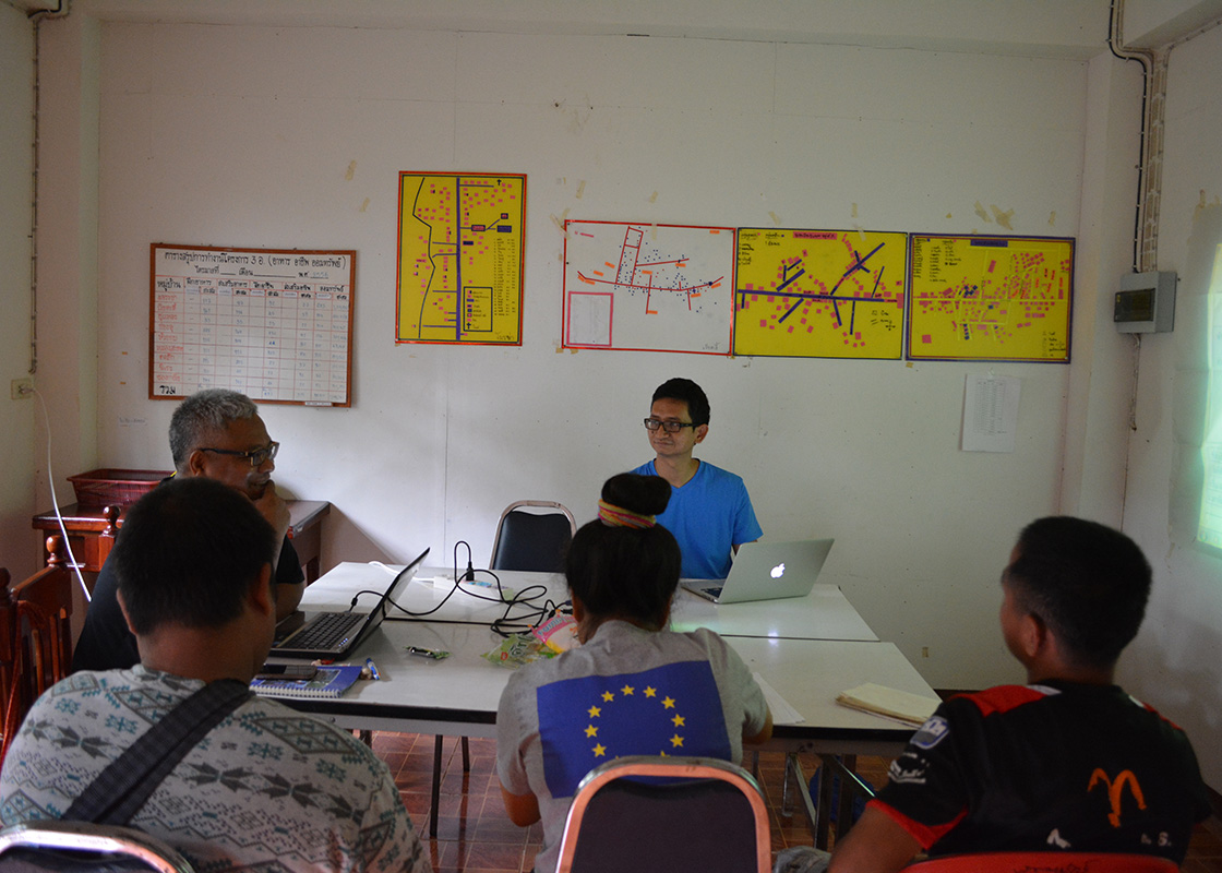 The team going over questionnaires that would be used in a follow-up community survey