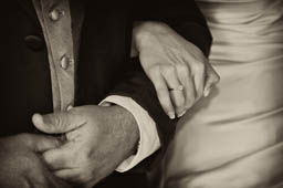 A photograph father holding his daughters arm before they walk down the aisle. Special moments between a bride and her father.