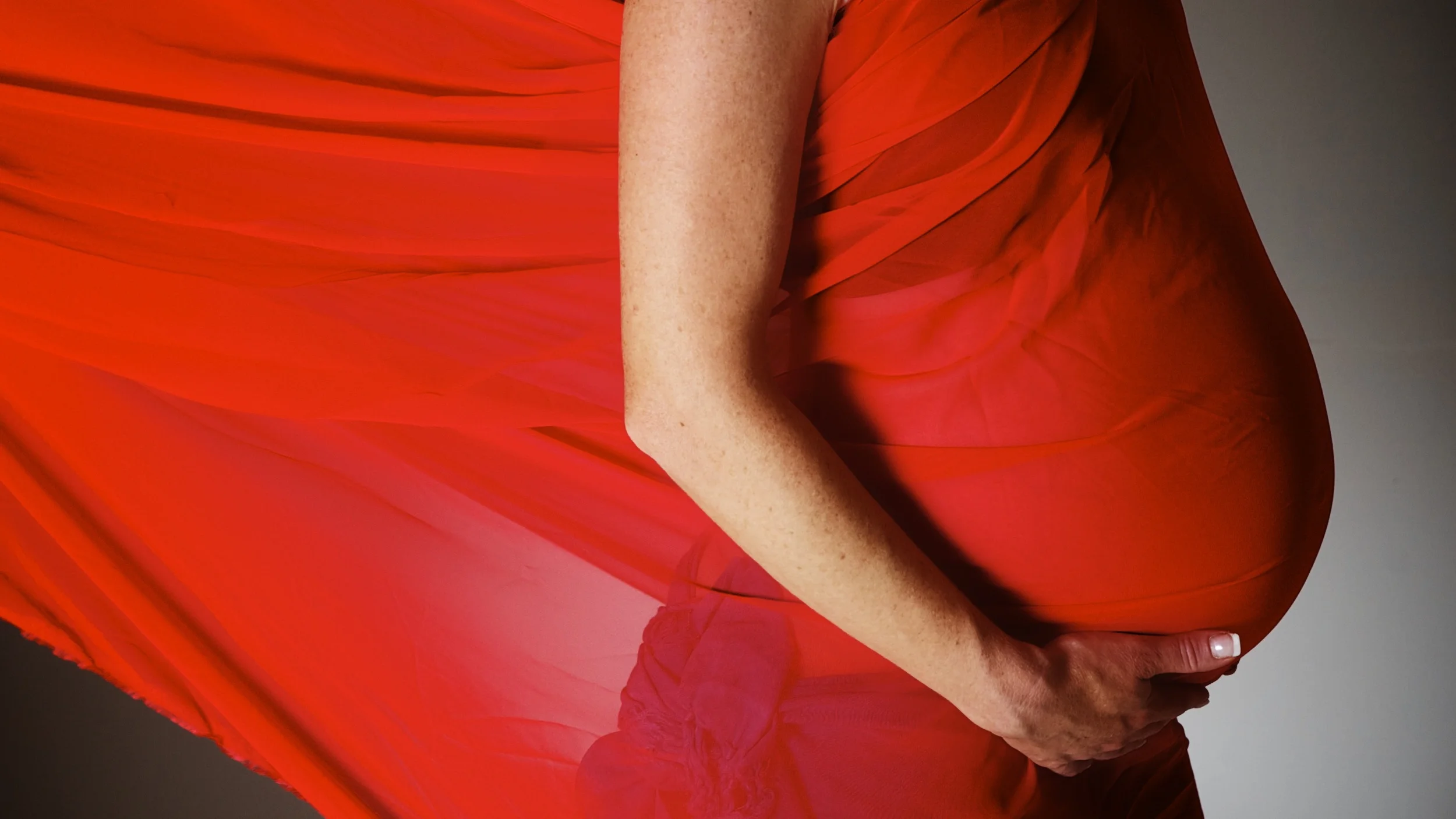 A beautiful image of an expecting Mum holding her belly during her Maternity photography. Image Taken by Warnock Imagery