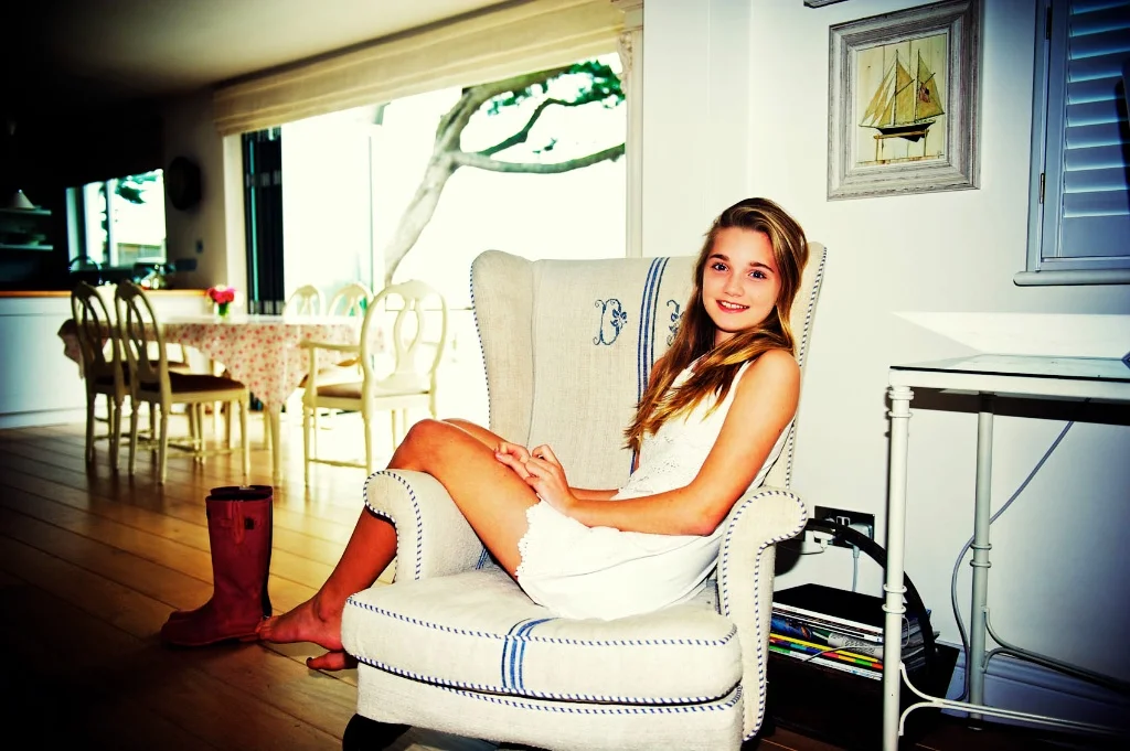 This photograph shows the importance having family photo season in your our home. The young girl relaxes in her favourite chair in her her on Jersey Chanel Islands.