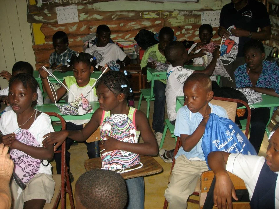 Children receiving new backpacks and Bibles