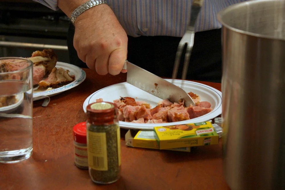  The ham is used whole, at first, to flavor the soup, and then removed, chopped and added back to the soup. Here sous chef John does some of the chopping. 