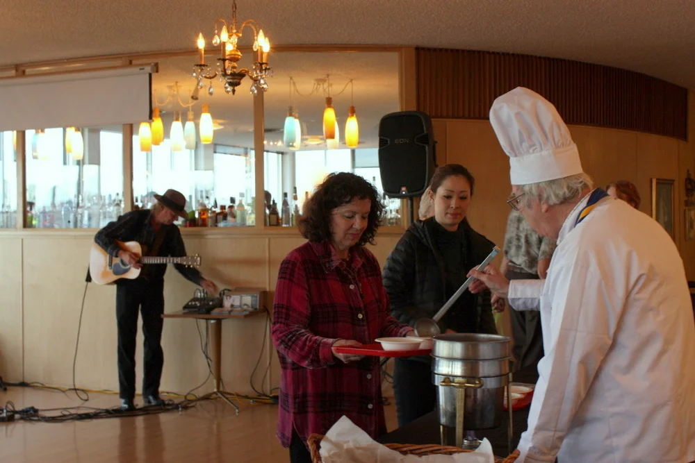  Dishing out some for the event volunteers as musician Bill Booth set up to play some tunes during dinner. 