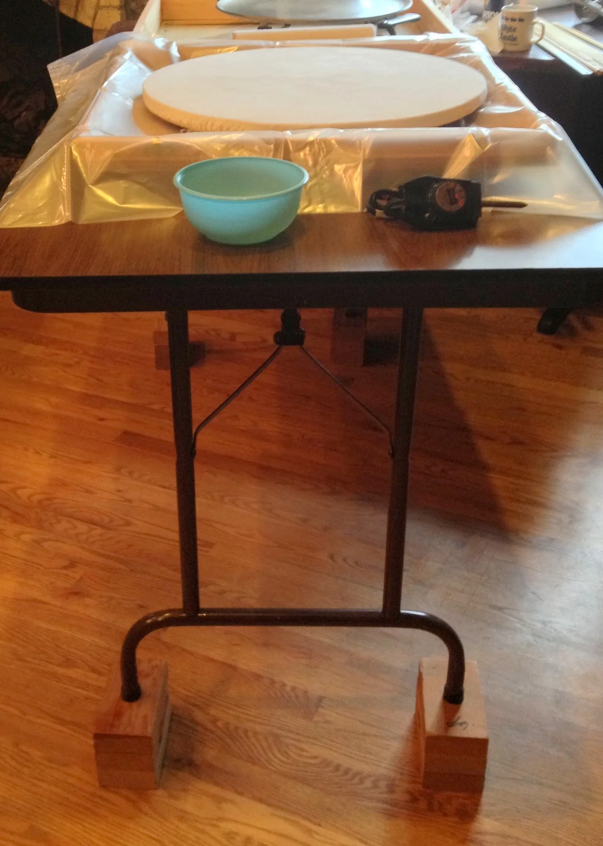  It's easier to roll on a higher counter, but if you are working on a table, you can make it a little more ergodynamic by raising it up a bit, as Mike did here with some bricks. 