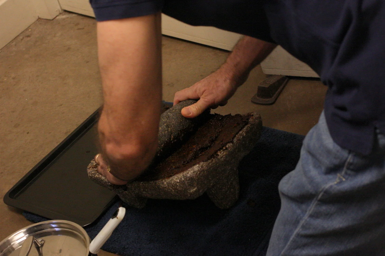  Our peppers were toasted to bring out flavor, the rehydrated in broth. After that, the class shredded and ground them on the metate. GIF of that here: http://cinemagr.am/show1/61848949 Amy's mom said that the saying is the metate has 4 legs: 3 on th