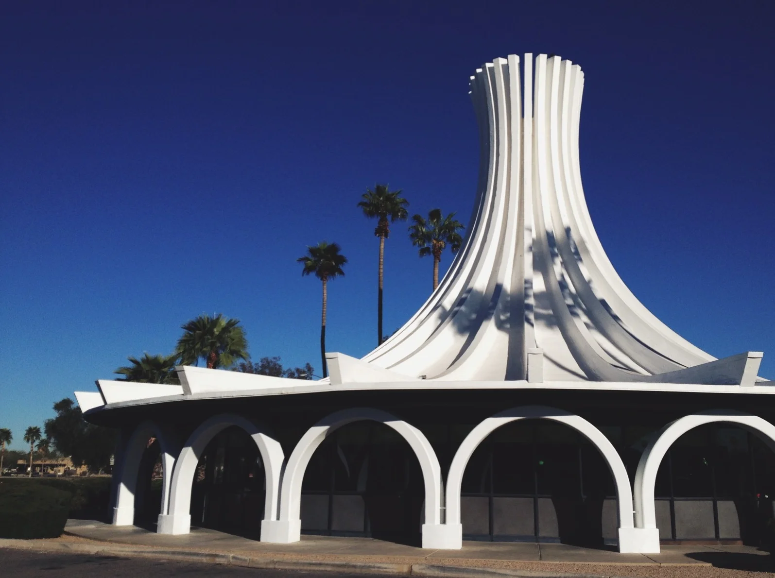  Architect W.A. Sarmiento. Per "Midcentury Marvels:" "to attract the attn of passing motorists, the roof structure of the building was exaggerated...inspiration may likely have come from the shape of Oscar Neimeyer's Expressionist cathedral in Brasil