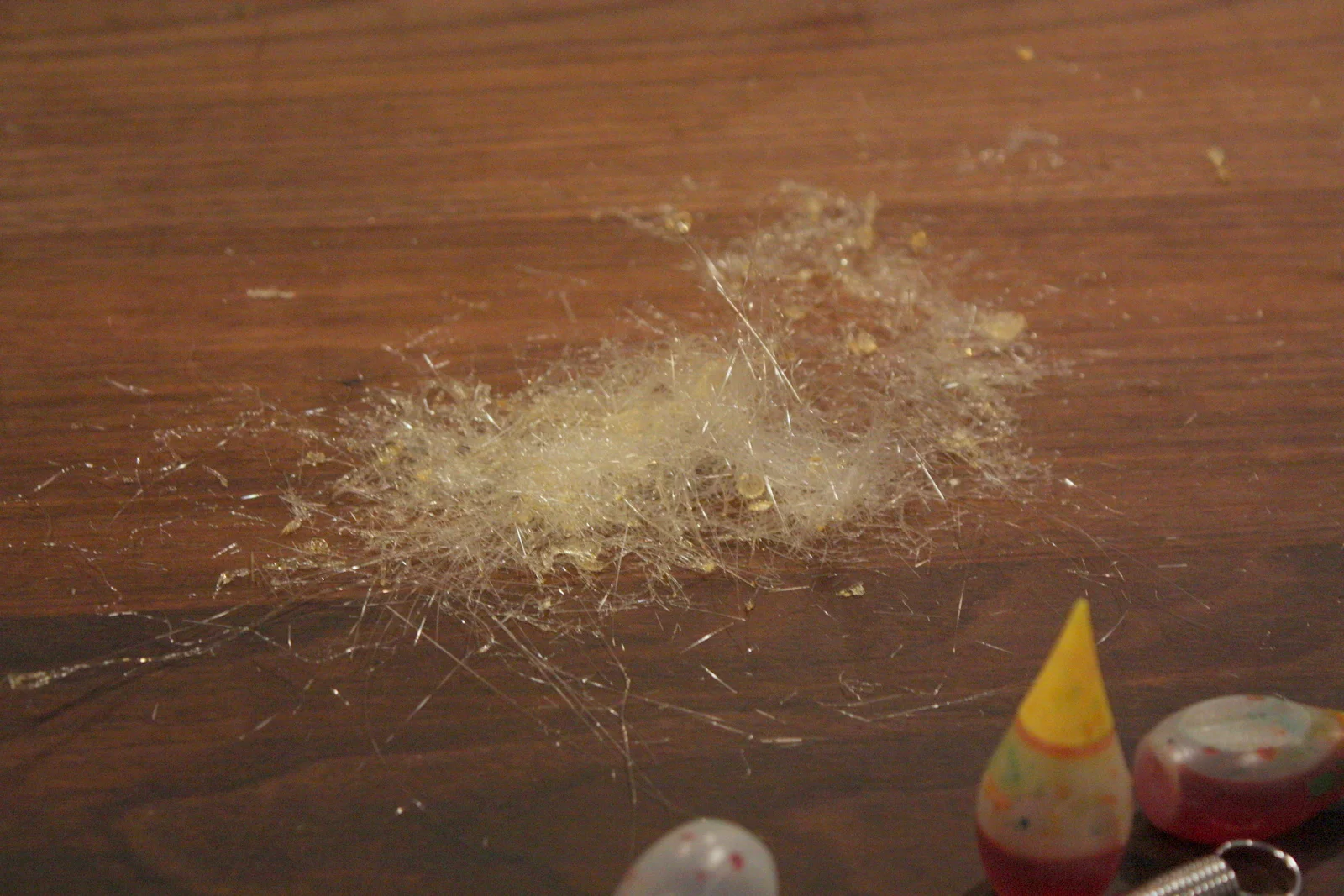  It definitely requires some practice to get the right timing between swishing and rolling. If you let it sit just a few seconds too long after swishing, or as the mixture cools and the floss gets thicker, you might end up with a pile of candy thread