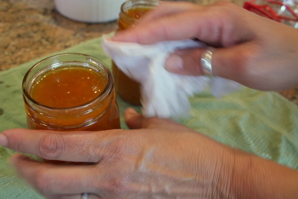  Crucial, but frequently forgotten by new canners: wiping off the rim of the jar. 