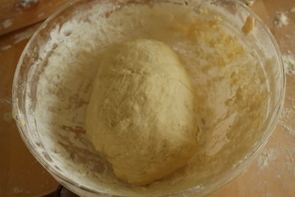 Dough kneaded, but it's not done. When making piroshky dough, fat is mixed into the dough after the initial kneading. 