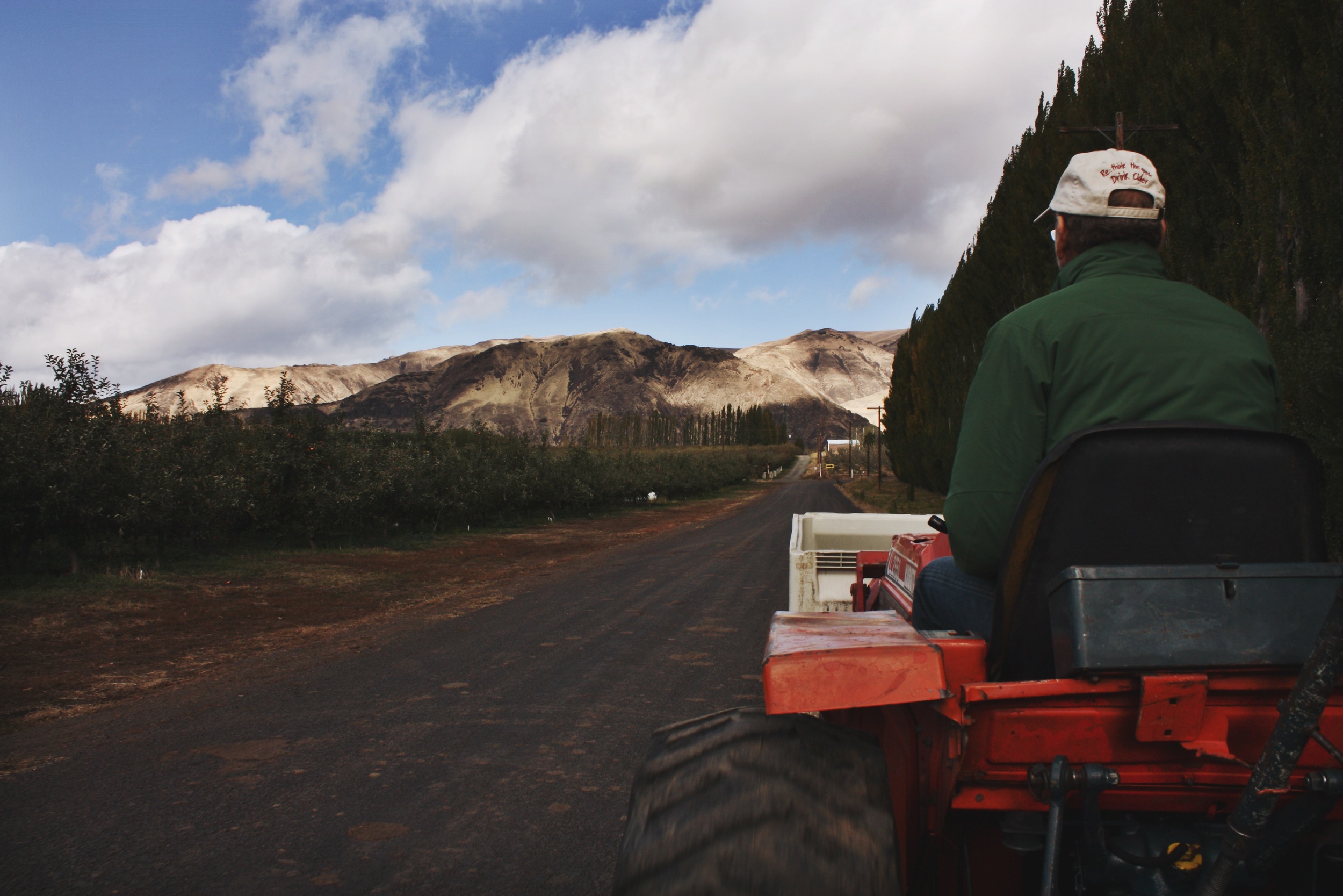   After intros, we clambered onto an open trailer and Craig Campbell, the owner (with his wife Sharon) of Harmony Orchards drove us out into the trees.  