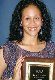 ICD graduate holding their certificate of achievement.