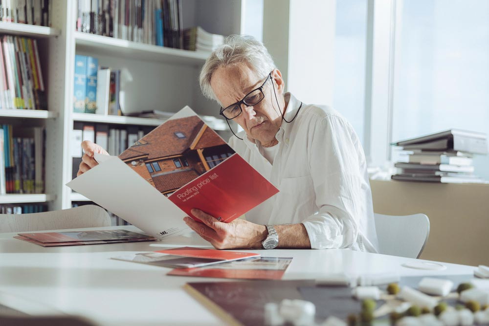 Architect in his office with brochure