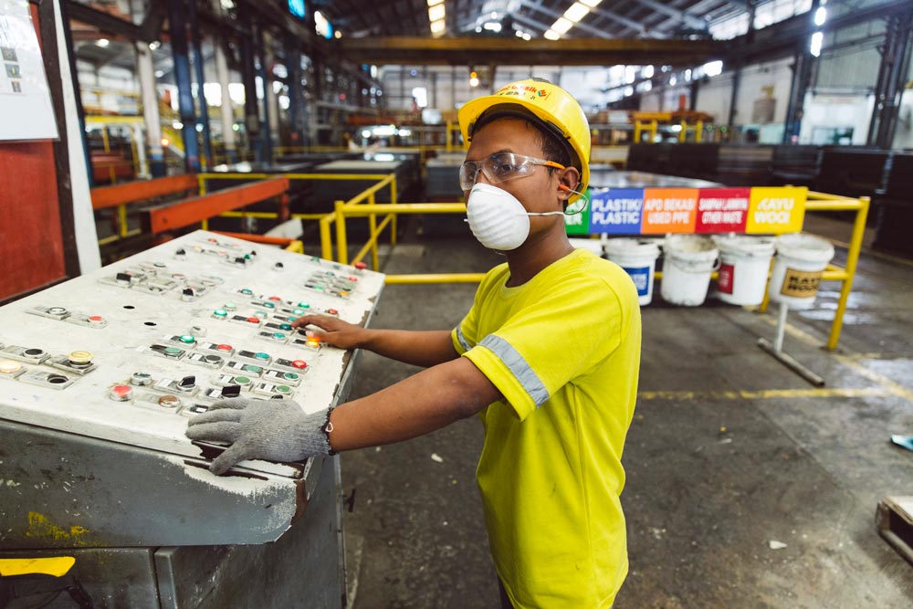 Man operating machine in Eternit Gresik factory