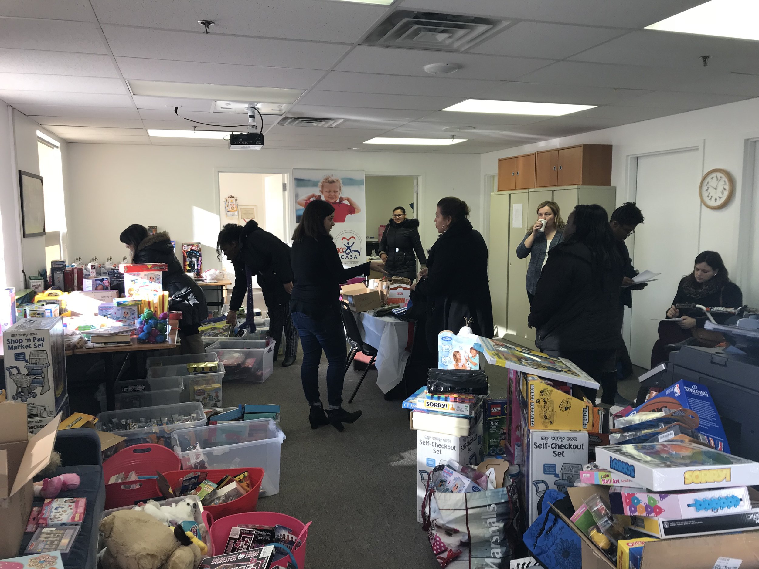  Caseworkers from the Division of Child Protection and Permanency (DCP&amp;P) pick up gifts for children in the child welfare system who aren't in foster care.&nbsp; 