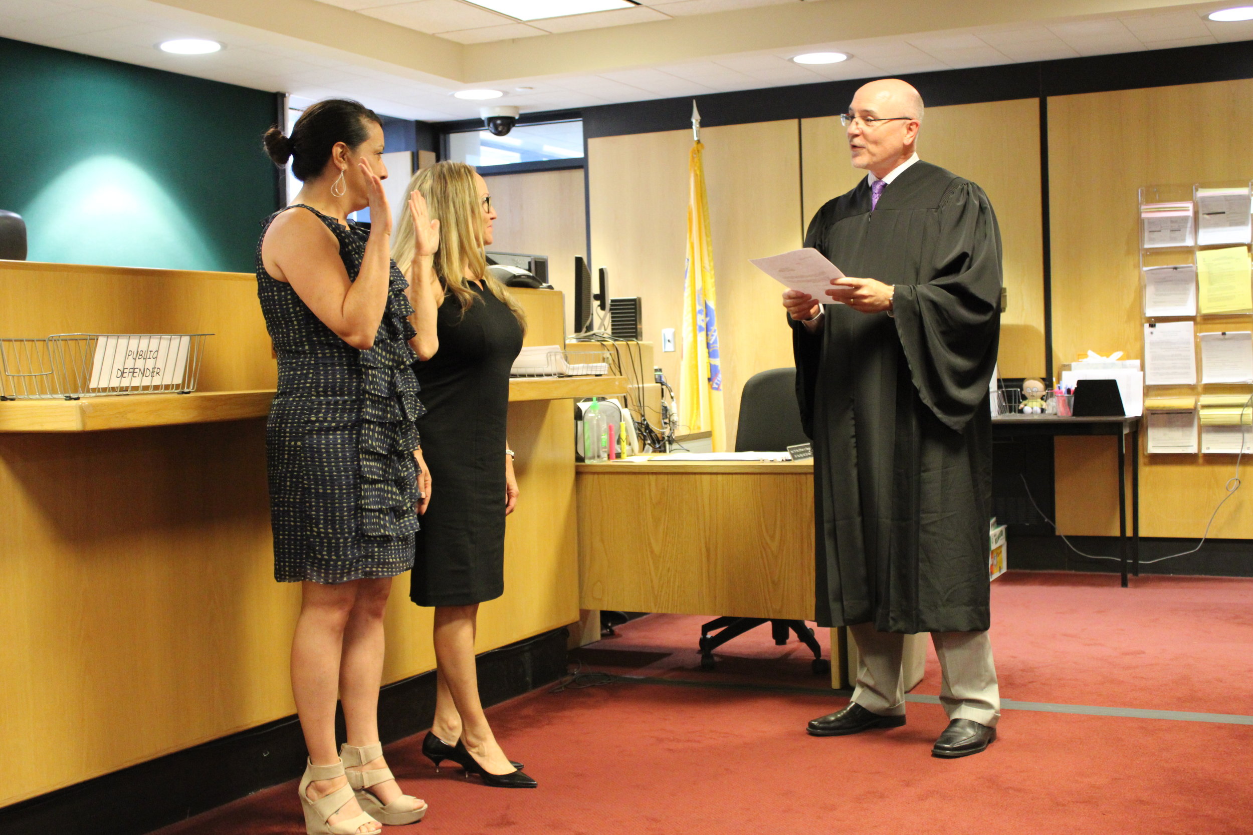 Lori Fasulo and Tracie Gonzalez take an oath to advocate on behalf of children in foster care.