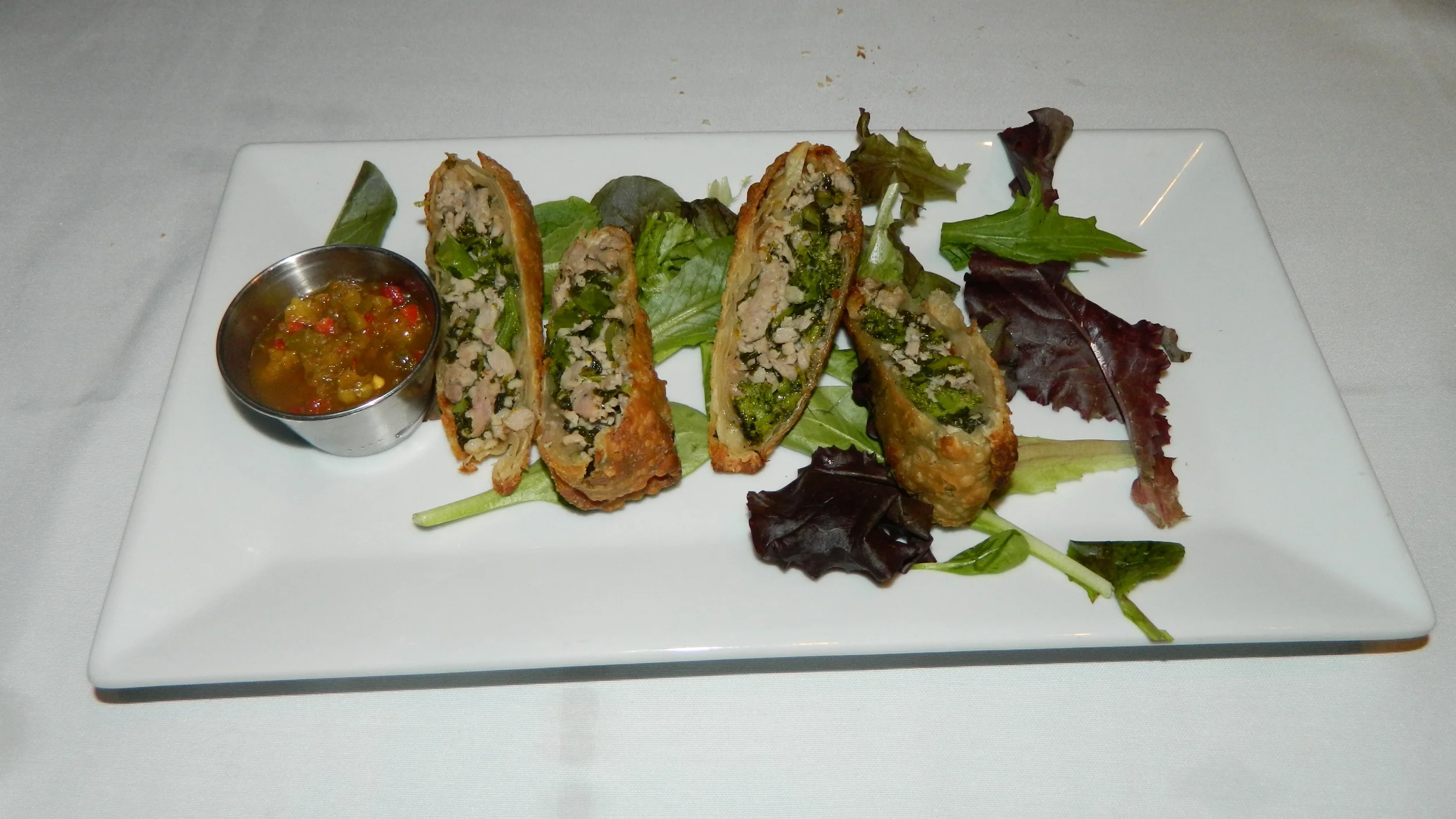 The broccoli rabe and sausage egg rolls with spicy Italian chimichurri sauce is an excellent appetizer.