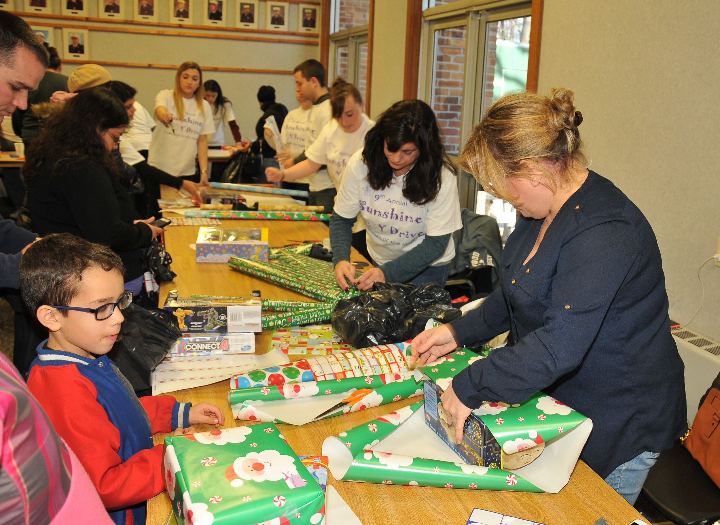 Volunteer personal shoppers and gift wrappers take to the toy store that was assembled at the Dix Hills firehouse last month as part of the ninth-annual Sunshine Toy Drive. Photo by Steve Silverman