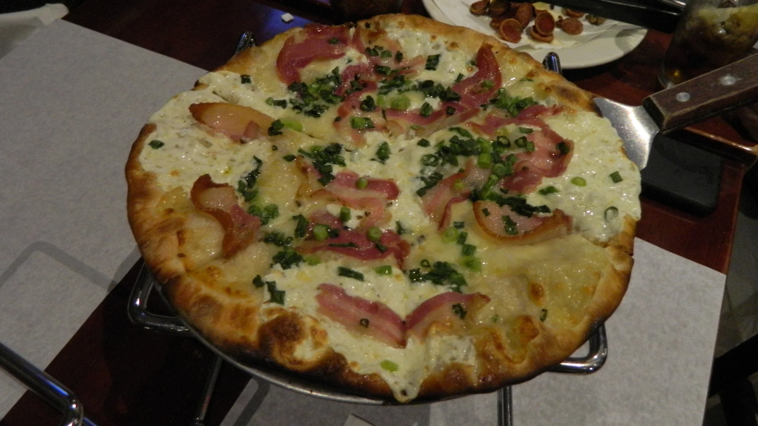 White pizza with pancetta and scallions is perfect for lovers of cheese and bacon.