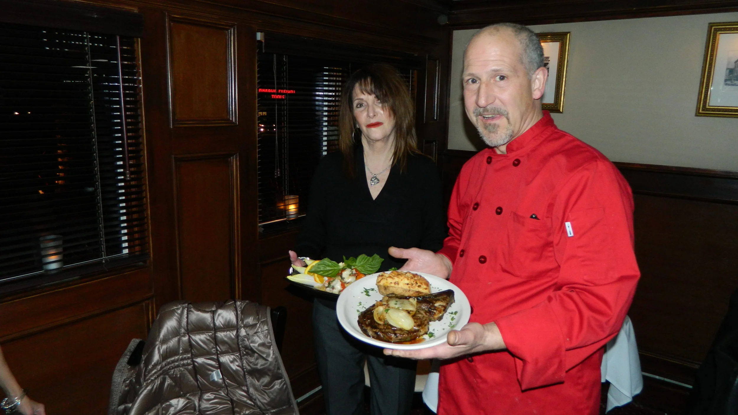 Clubhouse Co-owner Cassandra Bies and Chef Charles Labartino present bone-in ribeye steak and Chilean sea bass with shrimp entrees.